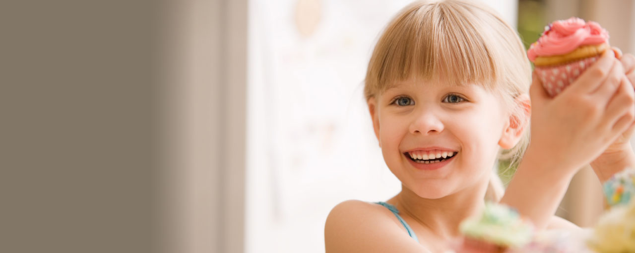 Young girl holding a cupcake