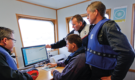 people looking at a monitor image people looking at a monitor image