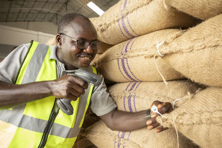 man scanning cocoa bean bag
