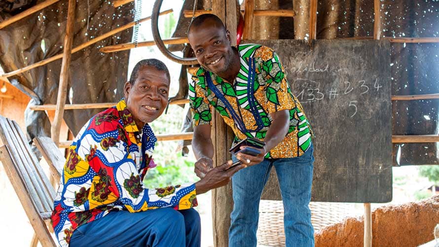 two cocoa farmers holding mobile phones two cocoa farmers holding mobile phones