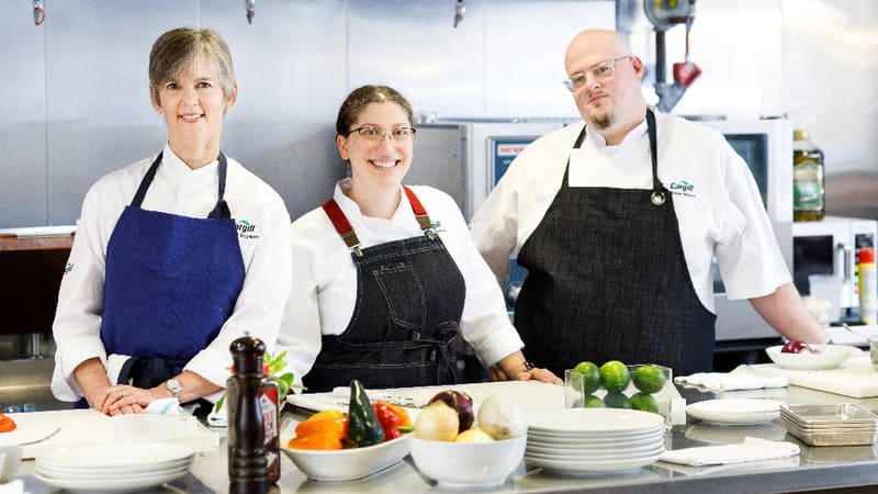 Chefs posing in kitchen  Chefs posing in kitchen