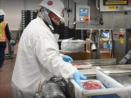 A plant employee examines packaged meat. The packaging process is now automated at more and more Cargill facilities. A plant employee examines packaged meat. The packaging process is now automated at more and more Cargill facilities.