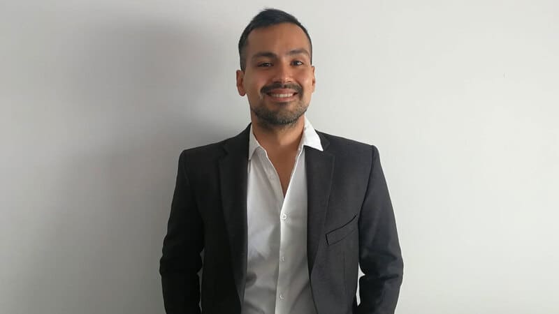 A man in a black blazer on a white background.  A man in a black blazer on a white background.