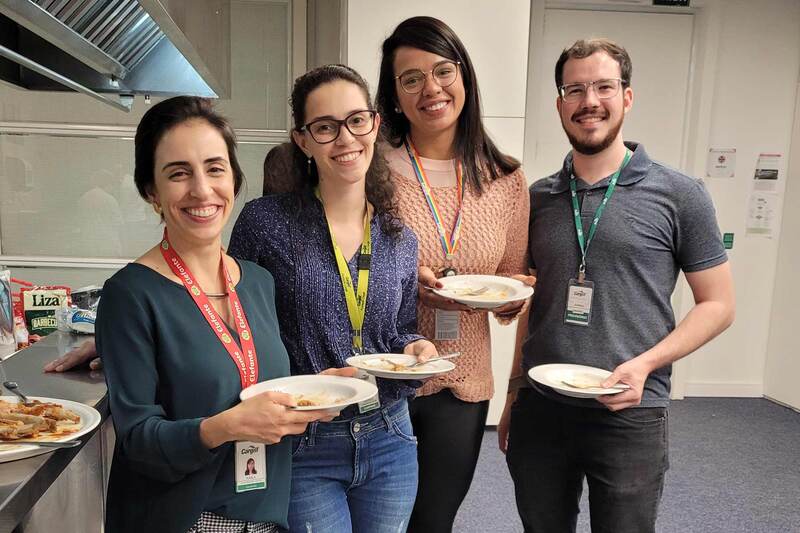 Four people stand in a food science lab after a BBQ tasting session.