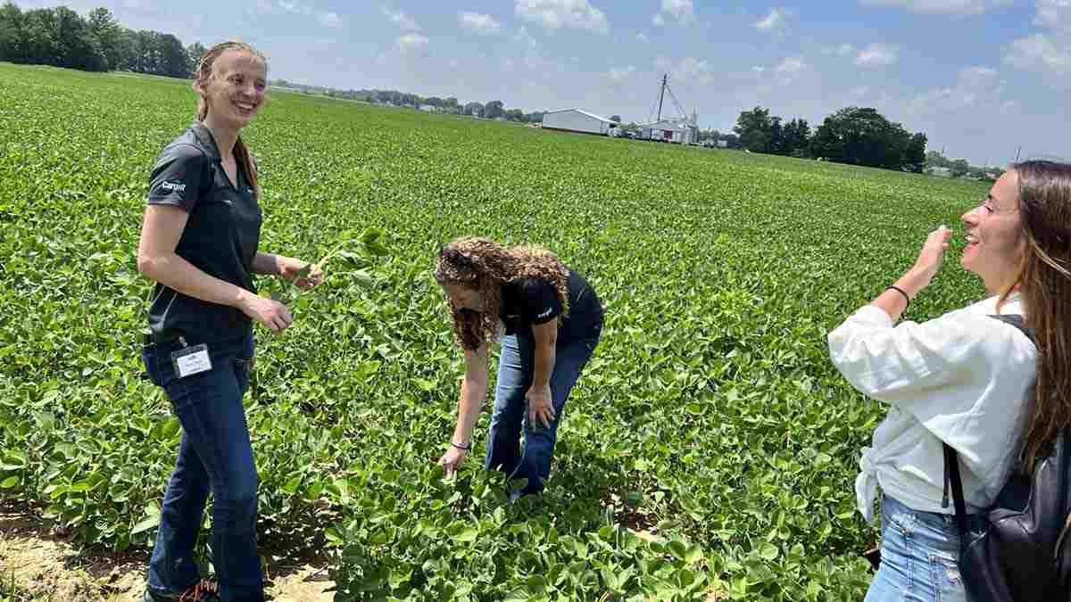 A group of people in a farm field.   A group of people in a farm field.