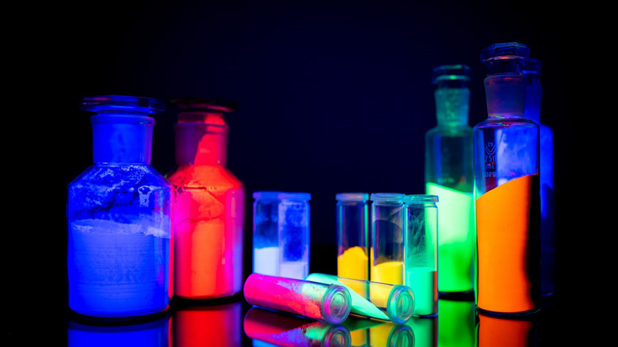 Twelve bottles full of bioluminesent pigment glow in the dark. 