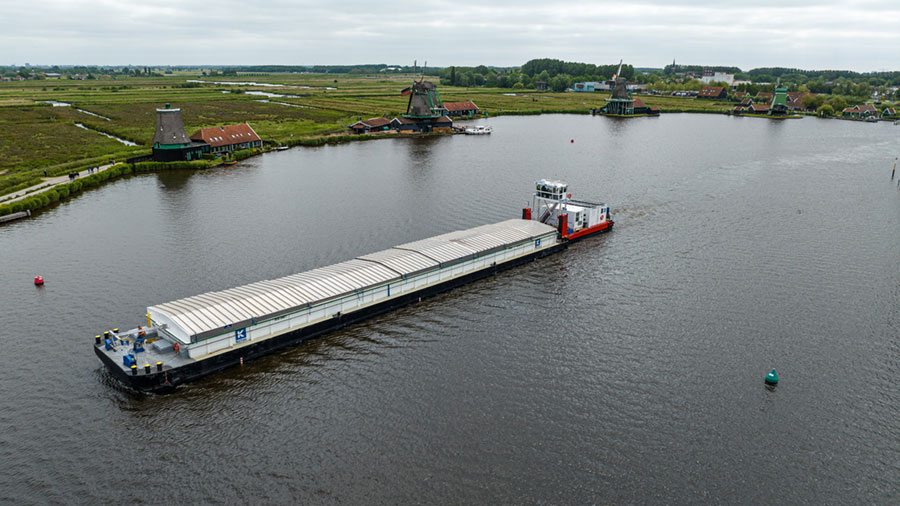 A large ship moves through the waters of a river in The Netherlands.  A large ship moves through the waters of a river in The Netherlands.