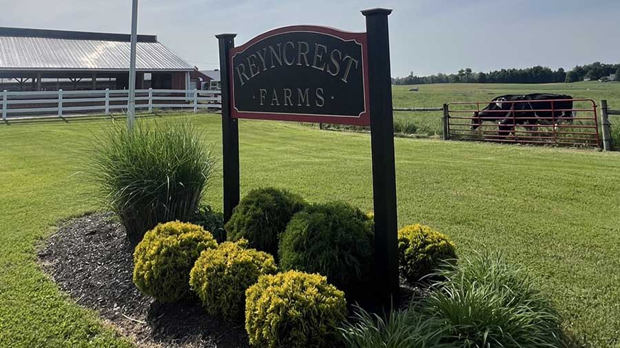 A large sign reads Reyncrest Farms.    A large sign reads Reyncrest Farms.