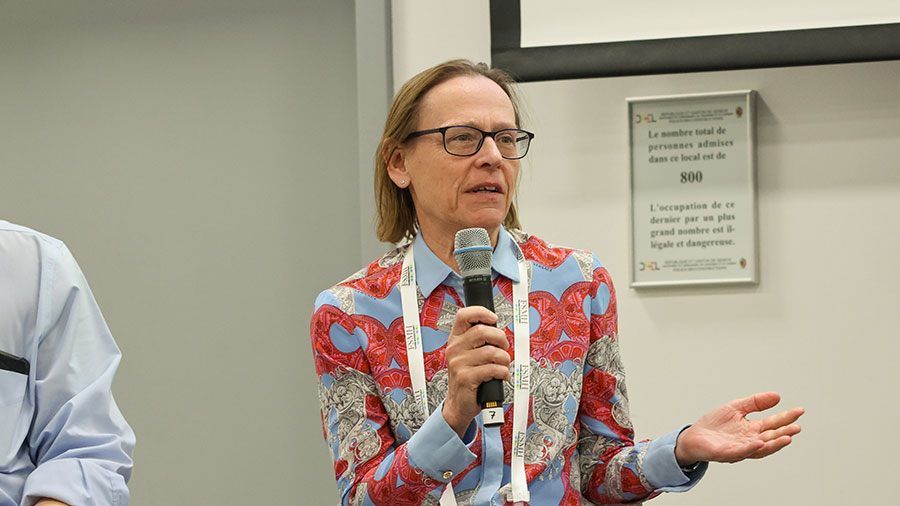 A woman speaks into a microphone. 